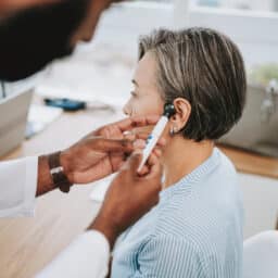Provider examining a patient's ear