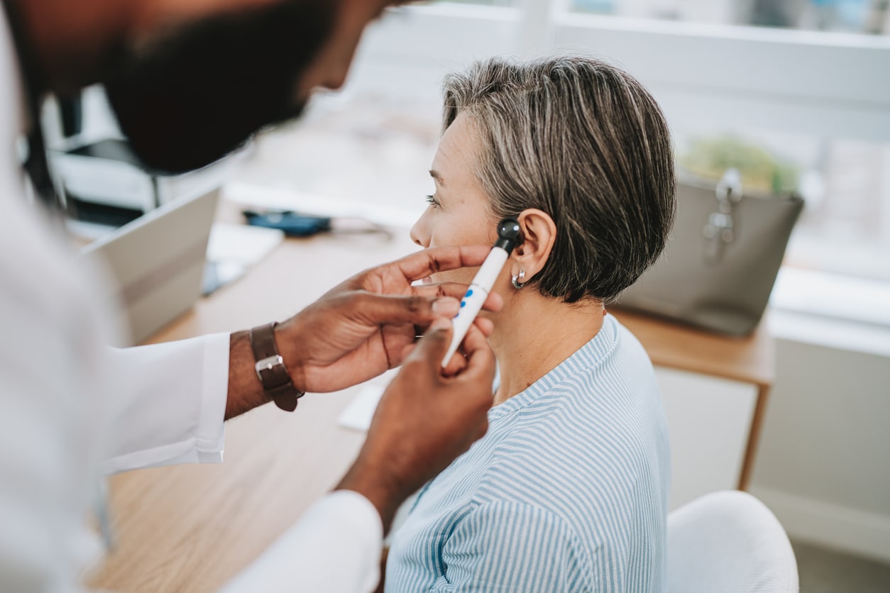 Provider examining a patient's ear.
