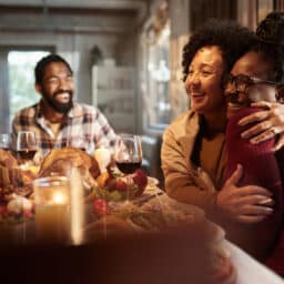 Mother and daughter hugging at Thanksgiving dinner