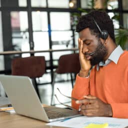 Tired man rubbing his face in exhaustion.