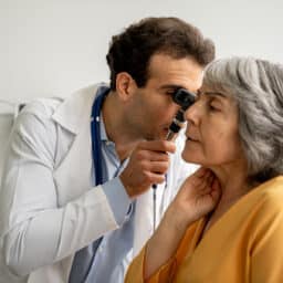 Doctor examining his patient's ear.
